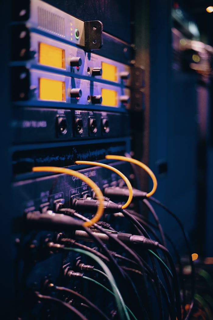 who-we-are Close-up of network cables and ports in a server rack, showcasing connectivity.
