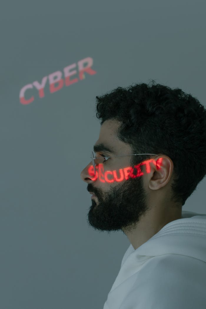 our-story Side profile of a man with 'CYBER SECURITY' projected on his face, emphasizing digital security themes.